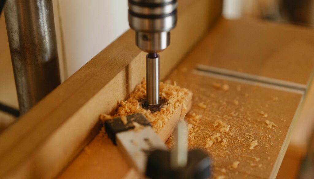Close-up of a wood drilling process in an industrial workshop.